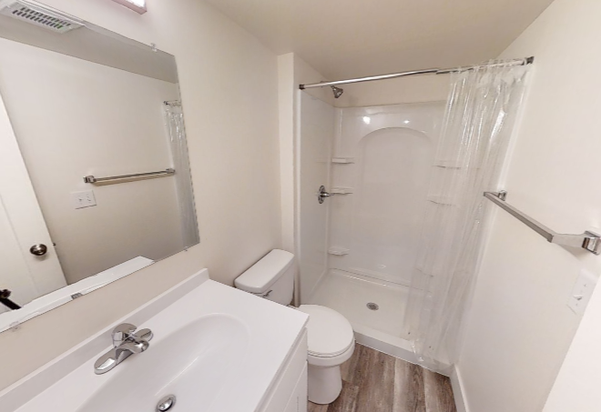 a bathroom with a sink toilet and shower